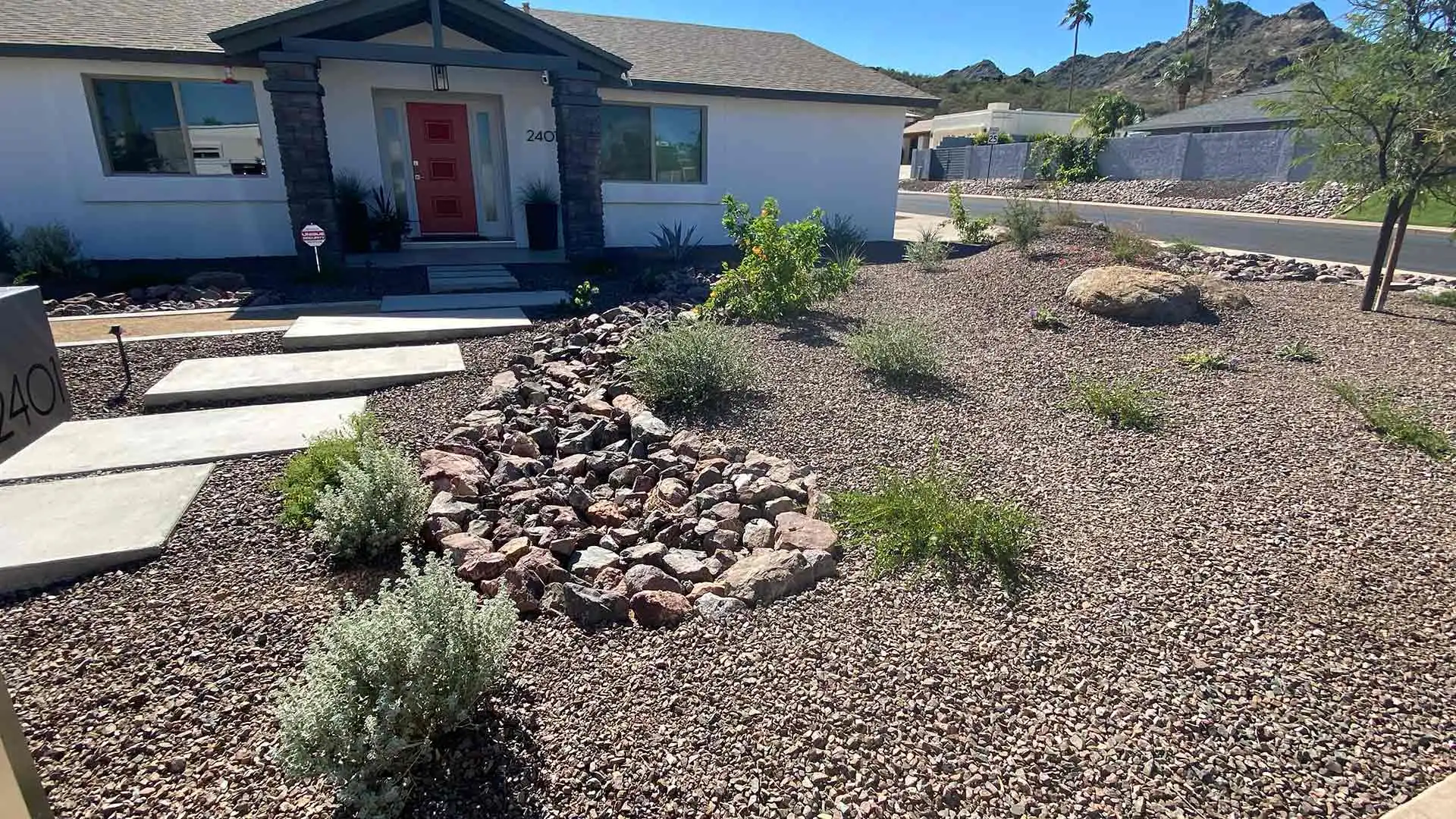 Rock mulch landscaping installed around a home in Phoenix, AZ.
