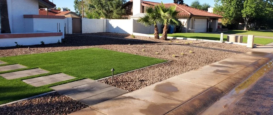A rock landscape with some artificial turf in Alhambra, AZ.