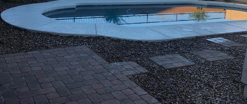 Rocks throughout landscape with a walkway installed in Laveen, AZ.