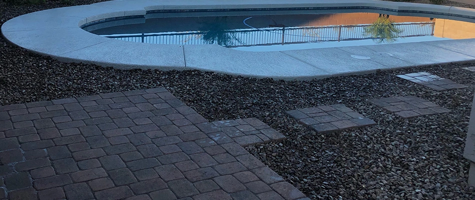 Rocks throughout landscape with a walkway installed in Laveen, AZ.