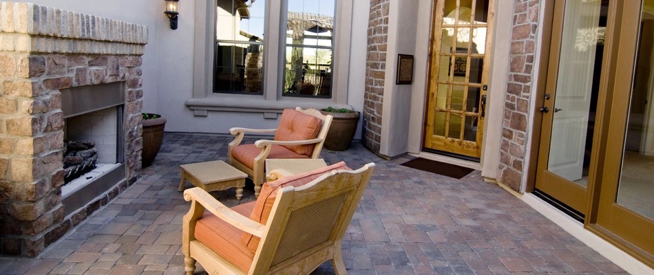 Stone outdoor fireplace installed over a patio in Glendale, AZ.