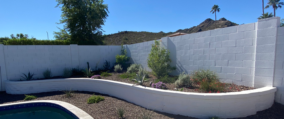 White brick retaining wall installed with plantings in Glendale, AZ.